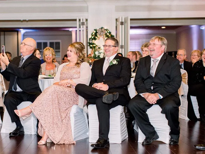 Guests laughing during a wedding reception program