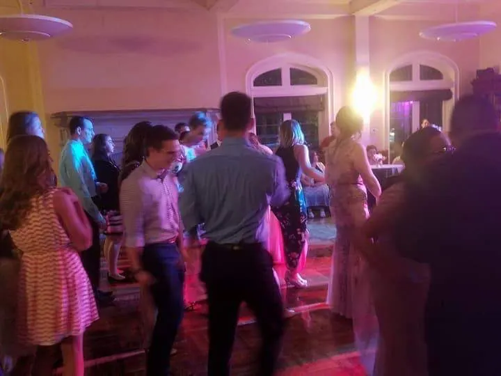 Guests dancing with raised hands at a wedding reception
